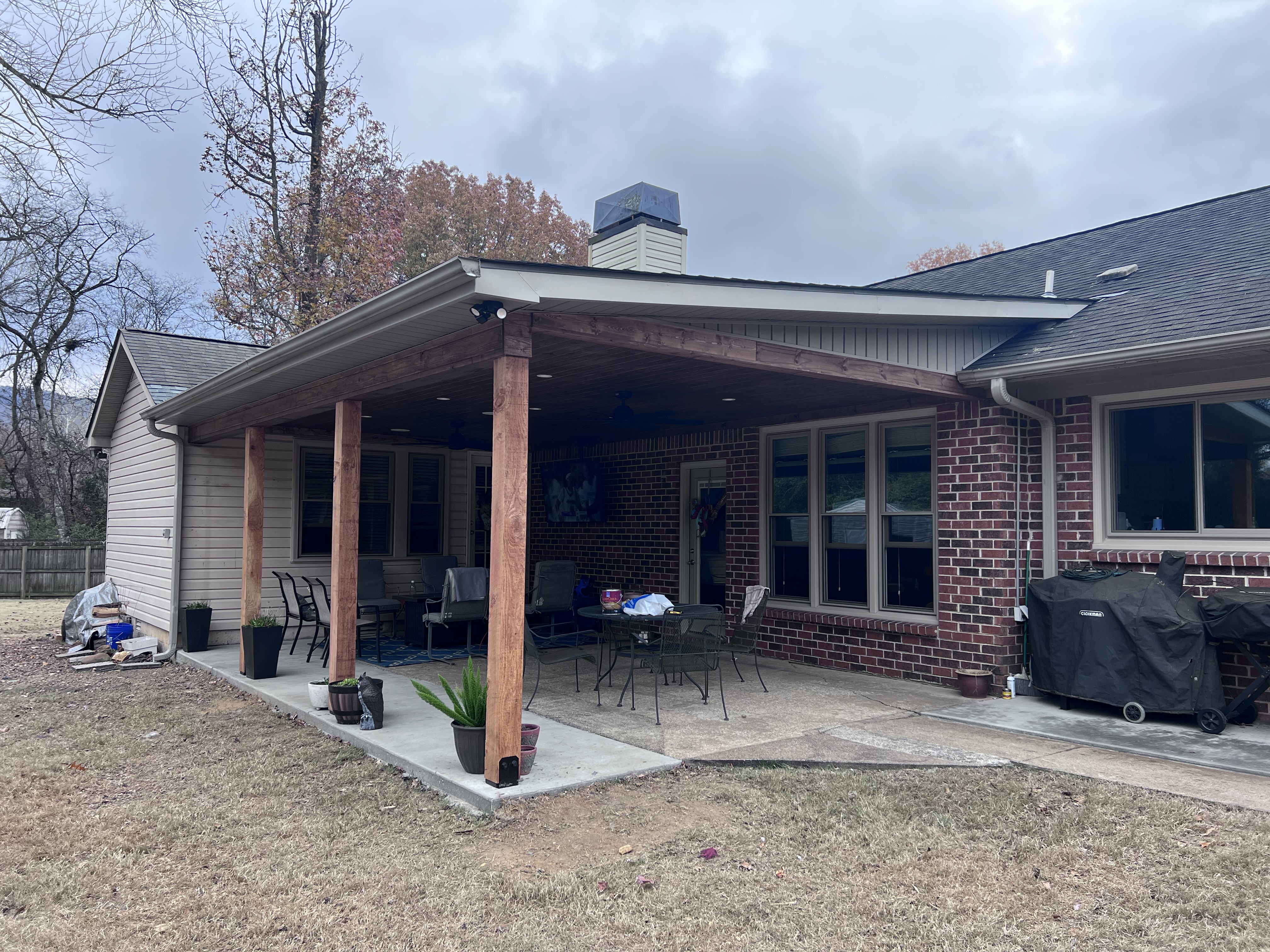 Covered patio with outdoor living seating and mounted TV