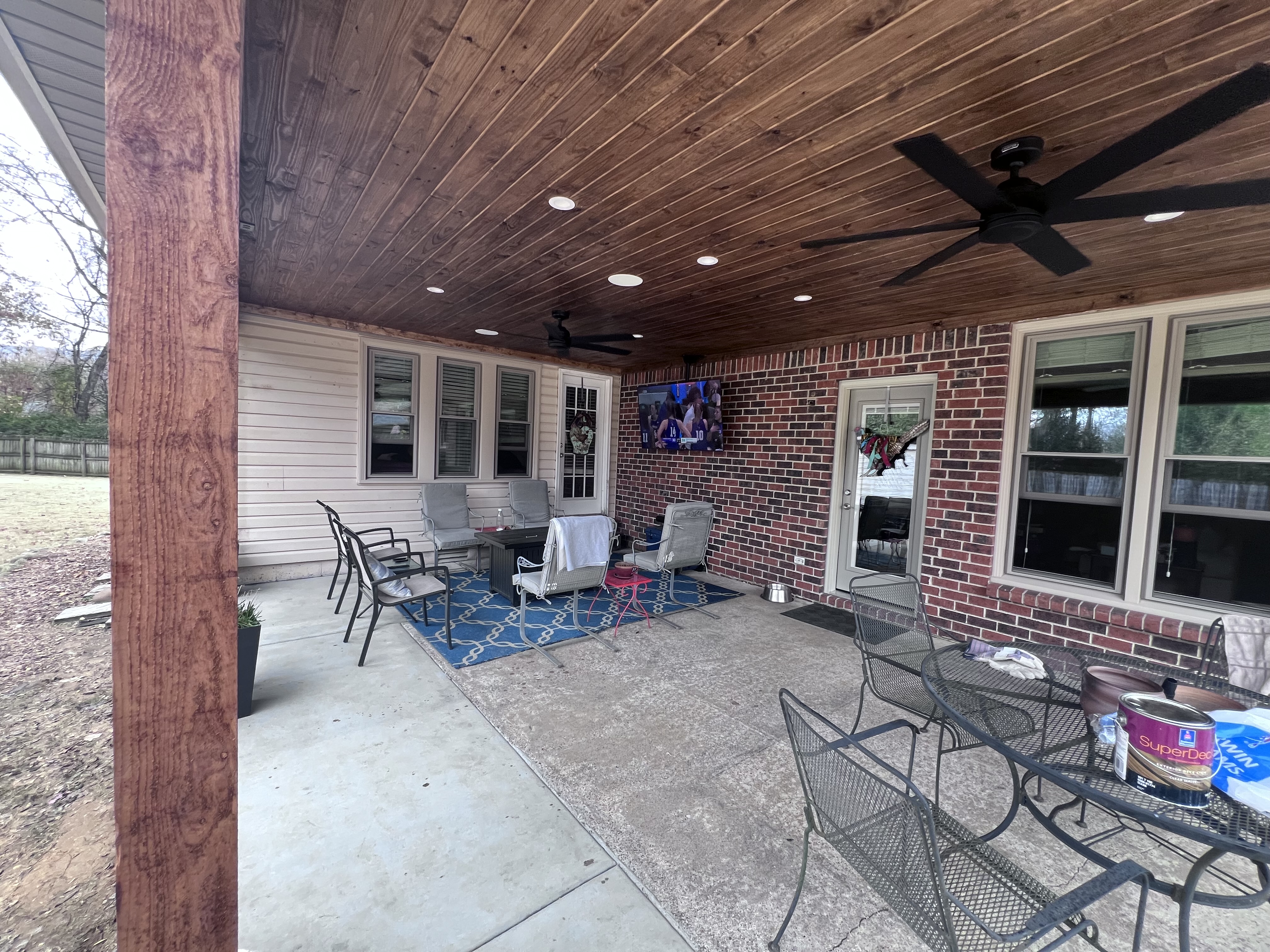 Patio cover interior with stained wood ceiling and recessed lighting
